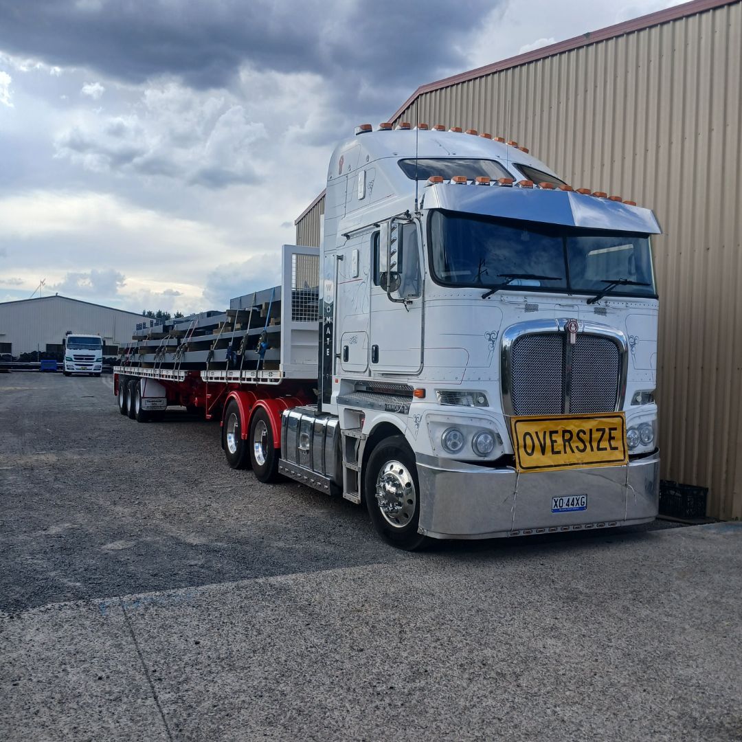 Swoomate prime mover with a loaded semi-trailer outside the workshop